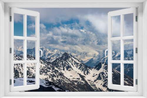 Fototapeta Naklejka Na Ścianę Okno 3D - Mountain clouds over beautiful snow-capped peaks of mountains and glaciers. View at the snowy mountains.