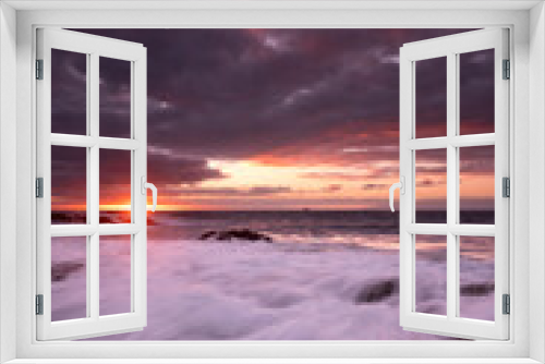 Fototapeta Naklejka Na Ścianę Okno 3D - Sunset landscape at the beach with sea ocean and waves in background - dramatic sky with sun and clouds - dusk light and horizon