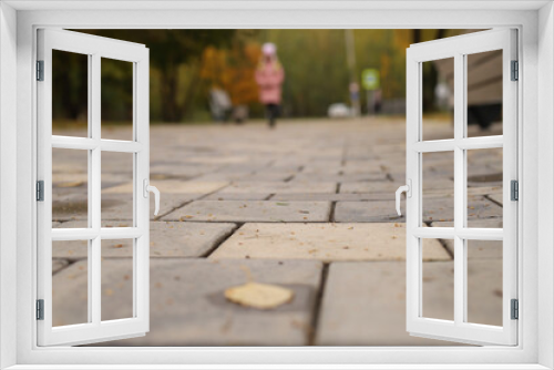 Fototapeta Naklejka Na Ścianę Okno 3D - a view from below of a street covered with stone paving stones with a blurred background
