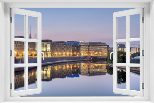 Modern office buildings at the river Spree in Berlin at dawn with the famous TV Tower in the back
