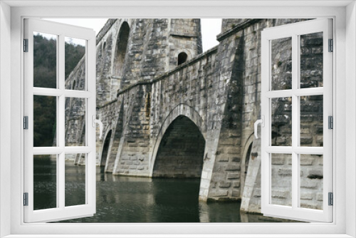 Fototapeta Naklejka Na Ścianę Okno 3D - Historic aqueduct. The Mağlova aqueduct, a work of Mimar Sinan, located in Istanbul. Historic stone building.