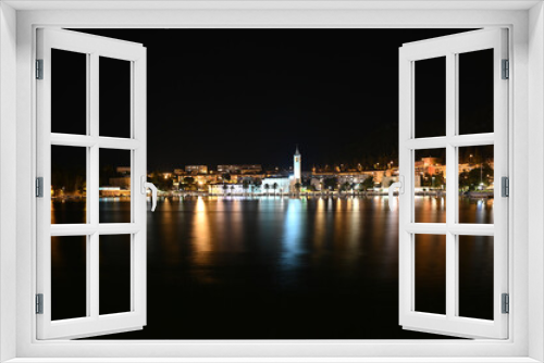 Fototapeta Naklejka Na Ścianę Okno 3D - City of Ploce and Adriatic sea in Croatia by night. Panoramic view of  buildings in town reflected in the water. 