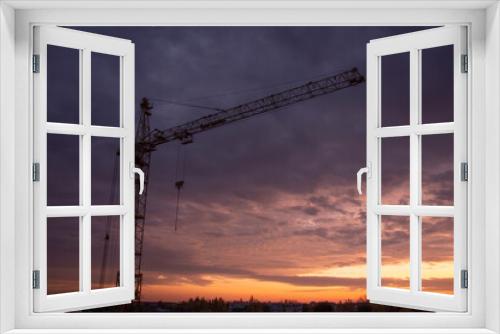 Fototapeta Naklejka Na Ścianę Okno 3D - Construction site with crane at sunset