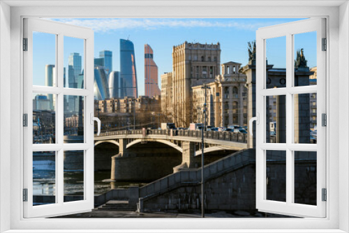 Landscape of modern Moscow city skyscrapers and ancient city architecture. Fantastic view of Borodinsky bridge on river Moscow, old buildings and high towers of Russia capital downtown. Moscow, Russia