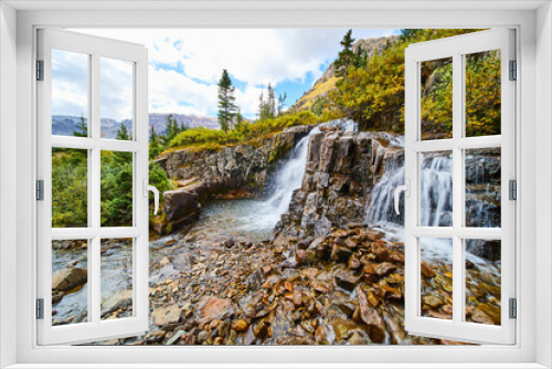 Fototapeta Naklejka Na Ścianę Okno 3D - Beautiful waterfalls over tiers of gray and brown rocks with view of open valley and mountains