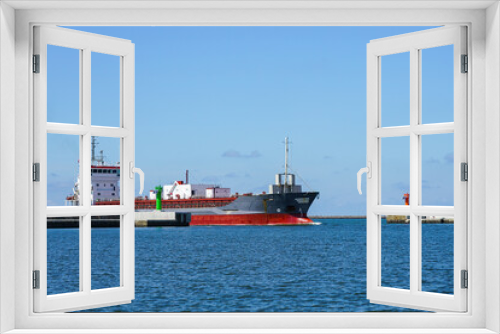 Fototapeta Naklejka Na Ścianę Okno 3D - the cement transport vessel enters the port through the breakwater gate