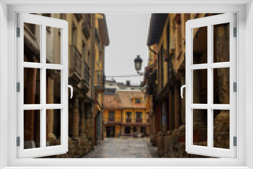 Fototapeta Naklejka Na Ścianę Okno 3D - Narrow street at medieval downtown in Aviles in the north of Spain
