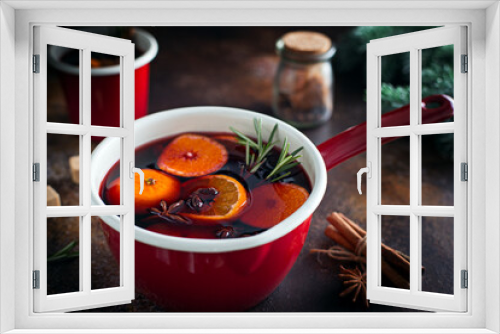 Fototapeta Naklejka Na Ścianę Okno 3D - Non-alcoholic mulled wine with tangerines and spices in an enamel ladle, selective focus