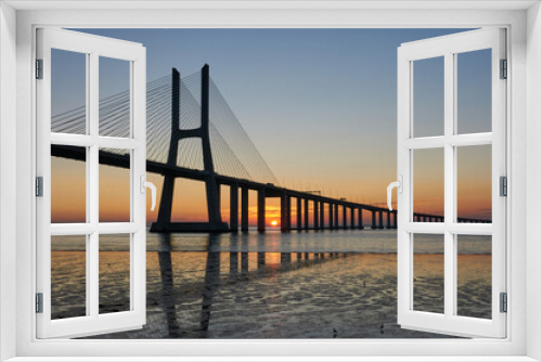 Fototapeta Naklejka Na Ścianę Okno 3D - Long exposure shot of Vasco da Gama bridge in Lisbon at sunrise