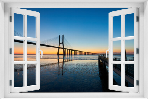 Fototapeta Naklejka Na Ścianę Okno 3D - Long exposure shot of Vasco da Gama bridge in Lisbon before sunrise