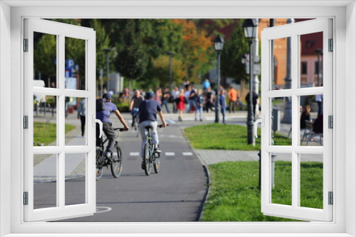 Fototapeta Naklejka Na Ścianę Okno 3D - Młodzi mężczyzni, chłopaki jadą na rowerach po ścieżce rowerowej we Wrocławiu.	

