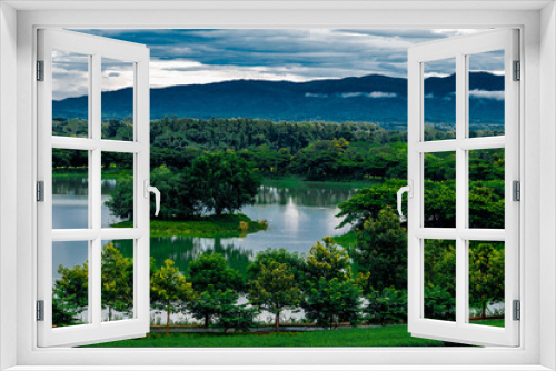 Fototapeta Naklejka Na Ścianę Okno 3D - Panoramic nature background (mountains, sea, trees, twilight lights in the sky, waterfront communities), naturally blurred through the wind, seen on tourist spots or scenic spots
