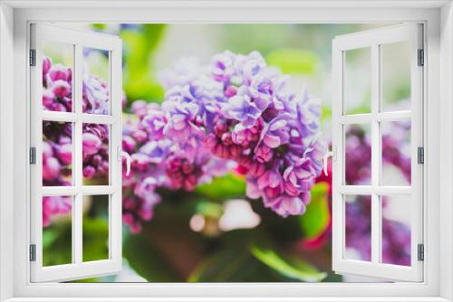 Fototapeta Naklejka Na Ścianę Okno 3D - close-up of bunch of purple flowers including lillac in vase indoor by the window