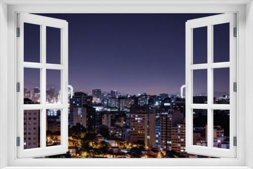 Fototapeta Naklejka Na Ścianę Okno 3D - Niterói, Rio de Janeiro, Brazil - CIRCA 2021: Long exposure urban night photography with buildings and lights of a Brazilian city
