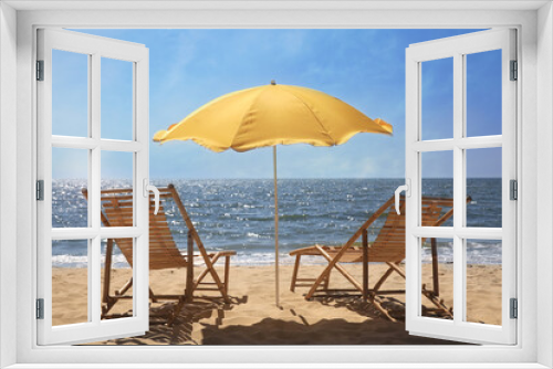 Fototapeta Naklejka Na Ścianę Okno 3D - Orange beach umbrella and deck chairs on sandy seashore