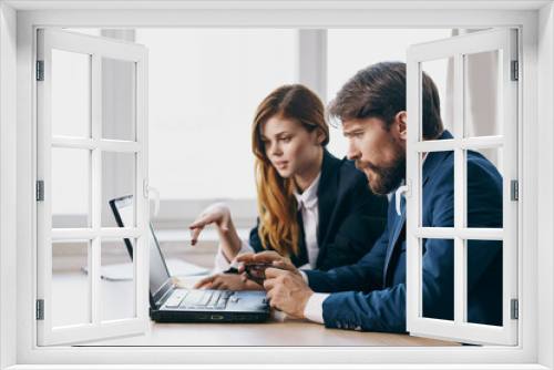 colleagues in the office in front of a laptop career work technologies