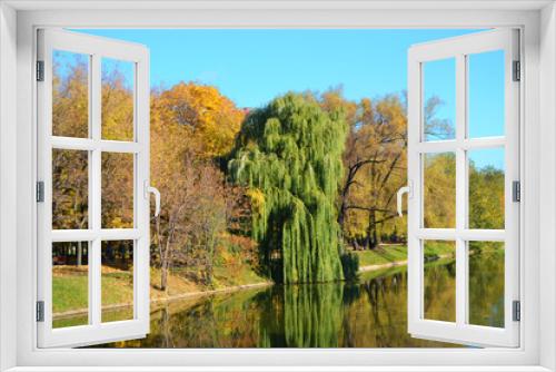 Fototapeta Naklejka Na Ścianę Okno 3D - Bright autumn landscape near the pond in the Novodevichy Monastery in Moscow, trees reflected in the water