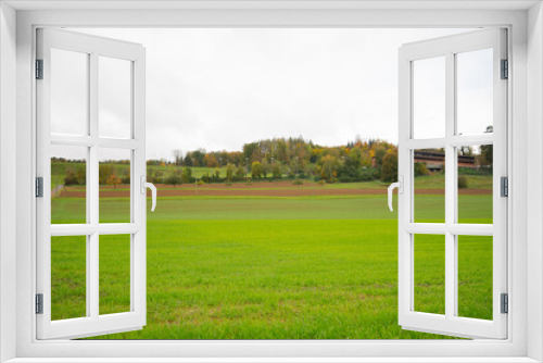 Fototapeta Naklejka Na Ścianę Okno 3D - field and sky with clouds in Switzerland