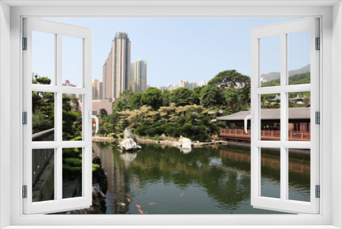 Fototapeta Naklejka Na Ścianę Okno 3D - Traditional wooden tea house and pond with goldfish in Nan Lian garden in Hong Kong
