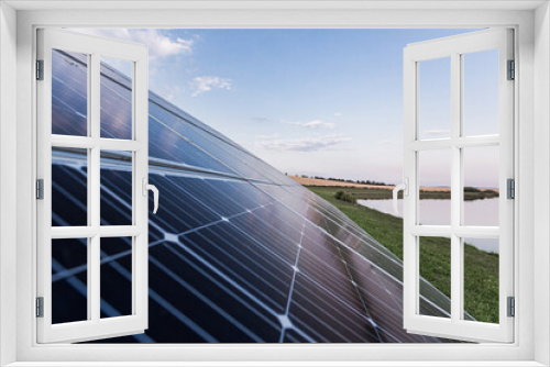 Fototapeta Naklejka Na Ścianę Okno 3D - Large solar panel near the lake with birds, renewable energy eco