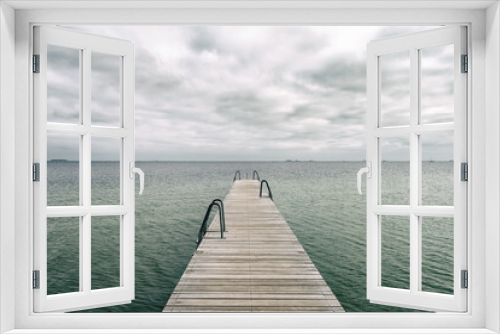 Fototapeta Naklejka Na Ścianę Okno 3D - Wooden pier leading to the sea. Baltic Sea, Copenhagen. Denmark. Freedom. Trips