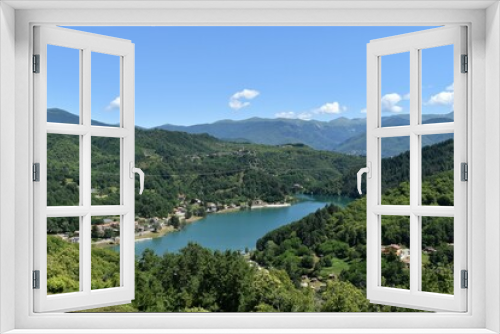 Fototapeta Naklejka Na Ścianę Okno 3D - Gramolazzo lake in Lunigiana, with boats and reflections, blue sky and no clouds, Apuan Alps in the background