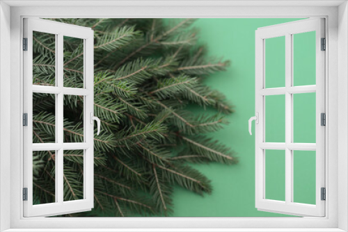 Fototapeta Naklejka Na Ścianę Okno 3D - Branches of a Christmas tree on a green background, Christmas background