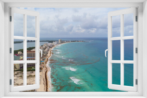 Fototapeta Naklejka Na Ścianę Okno 3D - Aerial view. Resort town, sandy beaches, tall houses, hotels. The turquoise water near the shore is polluted with algae. Cloudy sky. Climate change, global warming. Poisoning with wildlife toxins.