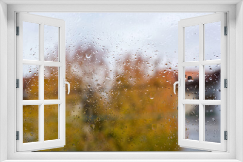 Fototapeta Naklejka Na Ścianę Okno 3D - Rain falls on the window on an autumn day. Weather and season concept. Close up, selective focus