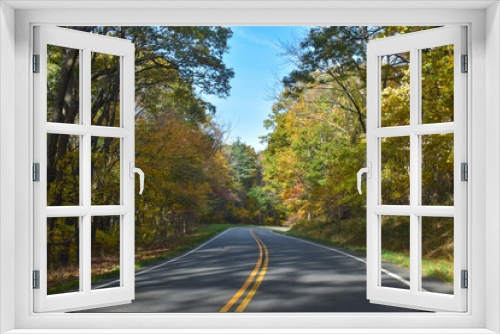 Fototapeta Naklejka Na Ścianę Okno 3D - Winding Country Road Traveling Through Beautiful Fall Foliage