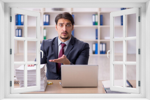 Young male employee working in the office