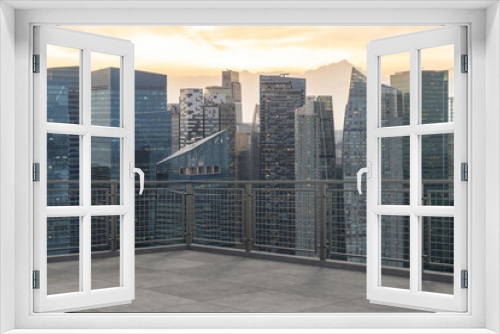 Fototapeta Naklejka Na Ścianę Okno 3D - Panoramic Singapore skyline view, concrete observatory deck on rooftop, sunset. Asian corporate and residential lifestyle. Financial city downtown, real estate. Product display mockup empty roof