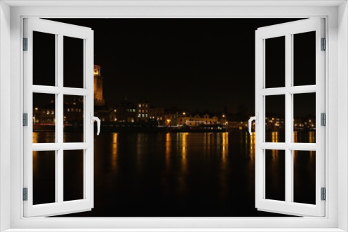 Fototapeta Naklejka Na Ścianę Okno 3D - The Great Church and buildings in the City of Deventer, the Netherlands, at night with reflection in the water
