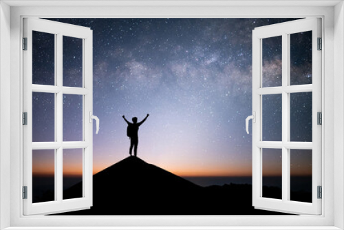 Fototapeta Naklejka Na Ścianę Okno 3D - Young traveler and backpacker standing and open arm watched the star and milky way alone on top of the mountain. He enjoyed traveling and was successful when he reached the summit.