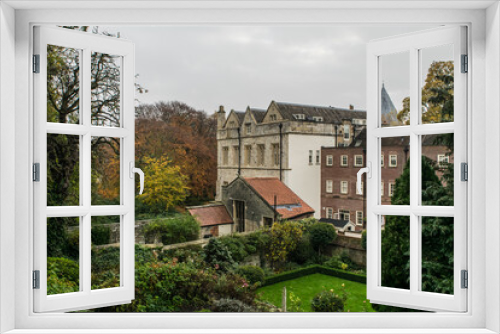 Fototapeta Naklejka Na Ścianę Okno 3D - Back view of old stone house next to modern brick house in York England