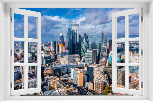 Aerial panoramic scene of the London city financial district with many iconic skyscrapers near river Thames.