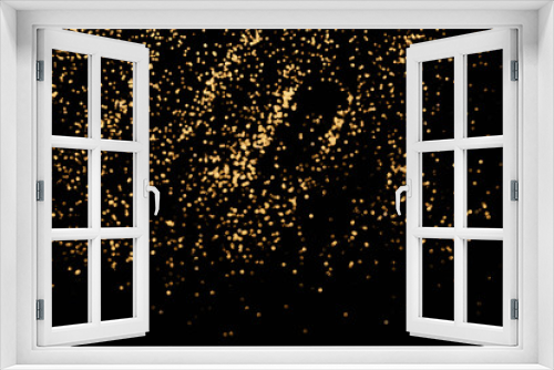 Black festive background. Abstract scattering of gold sparkles on black. Christmas backdrop, selective focus