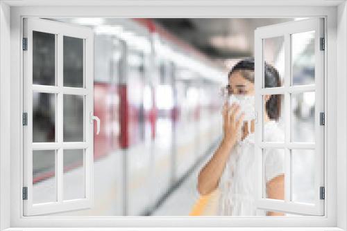 woman wearing Protective face mask prevention coronavirus inflection during waiting train. public transportation. social distancing, new normal and safety under covid-19 pandemic