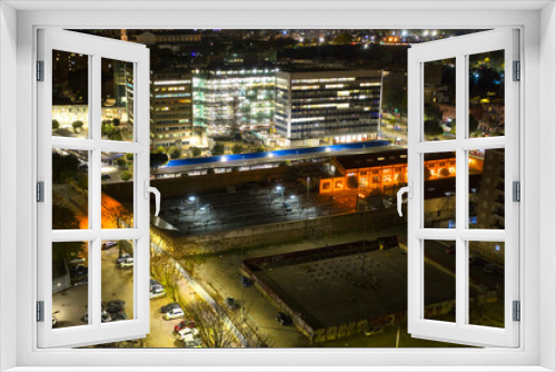 Fototapeta Naklejka Na Ścianę Okno 3D - Aerial night view of an industrial area of a large Italian city with warehouses, offices and buildings. 