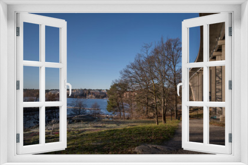 Fototapeta Naklejka Na Ścianę Okno 3D - Side view of the concrete bridge Tranebergsbron between the districts Kungsholmen and Bromma, inaugurated 1934. View point with a bench a sunny color full autumn day in Stockholm
