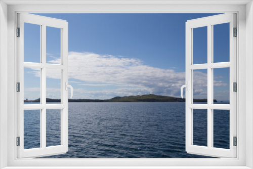 Fototapeta Naklejka Na Ścianę Okno 3D - day view of the sea, islets, capes, white clouds and blue sky in the Novik harbor on island Russky in Vladivostok, Russia