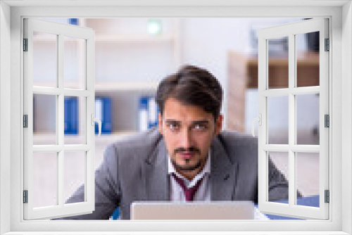 Young male employee working in the office