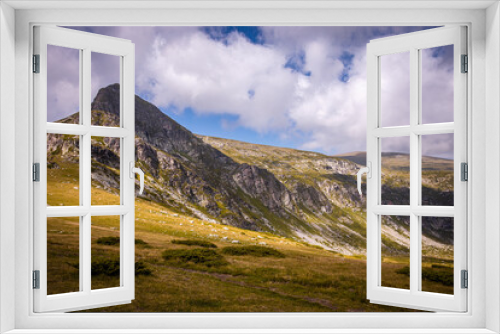 Fototapeta Naklejka Na Ścianę Okno 3D - Bulgarian landscape of a mountain peak in Rila mountain.Beautiful nature landscape.Green grass and blue sky with clouds. High quality photo