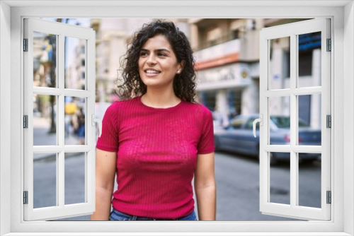 Young latin woman smiling confident standing at street