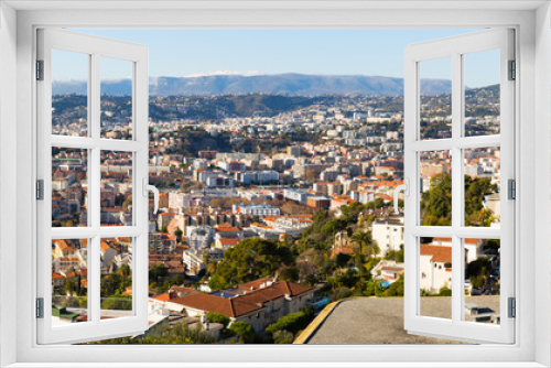 Fototapeta Naklejka Na Ścianę Okno 3D - Panoramic view of Nice residential districts against backdrop of Alps in sunny day, France