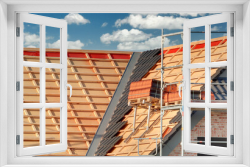 Fototapeta Naklejka Na Ścianę Okno 3D - Bauarbeiten / Dachdeckerarbeiten am eingerüsteten Neubau / Rohbau auf der Baustelle mit ungedecktem Dach