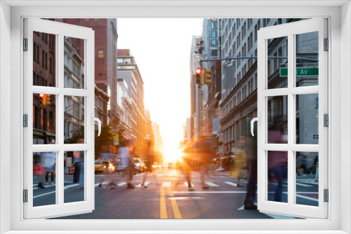 Fototapeta Naklejka Na Ścianę Okno 3D - Busy street scene is crowded with people at an intersection on Fifth Avenue in New York City with sunlight shining between the buildings
