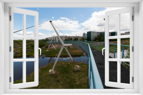 Fototapeta Naklejka Na Ścianę Okno 3D - pedestrian bridge over the river in summer in the city