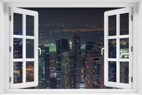 Fototapeta Naklejka Na Ścianę Okno 3D - JLT skyscrapers near Sheikh Zayed Road aerial night timelapse. Residential buildings