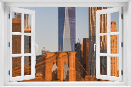 Fototapeta Naklejka Na Ścianę Okno 3D - Travel to New York. The skyline of Manhattan photographed during a summer sunrise, view to Brooklyn Bridge. Landmarks of United States of America. Skyscraper office buildings.